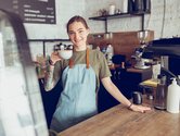 Vrouw achter de koffiebar aan het werk