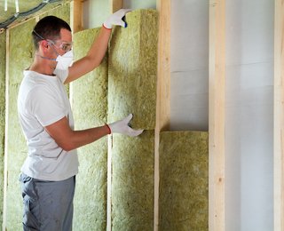 man is muur aan het isoleren