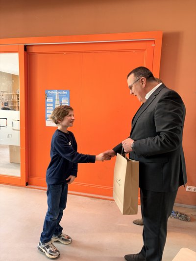 wethouder Dion Dankers en Olivier schudden elkaar de hand